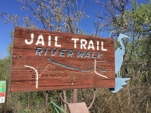Sign for Jail Trail River Walk, featuring a map of the trail along the Verde River and a heron silhouette.