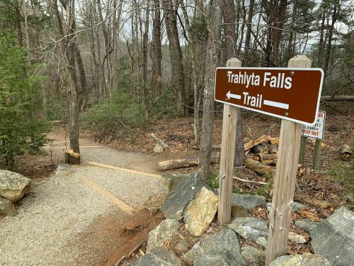 Signpost for Trahlyta Falls Trail, with a gravel path leading into a wooded area.