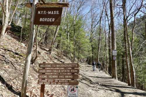 Signpost at the N.Y.-Mass. border, with trails for hiking and scenic viewing in Bash Bish Falls State Park.