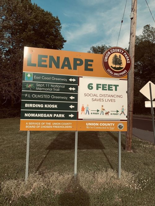 Sign for Lenape Park with directions to various trails and a reminder for social distancing of 6 feet.