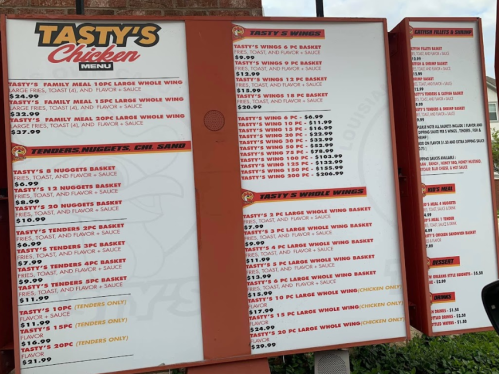 Menu board for Tasty's Chicken featuring various wing, tender, and sandwich options with prices listed.