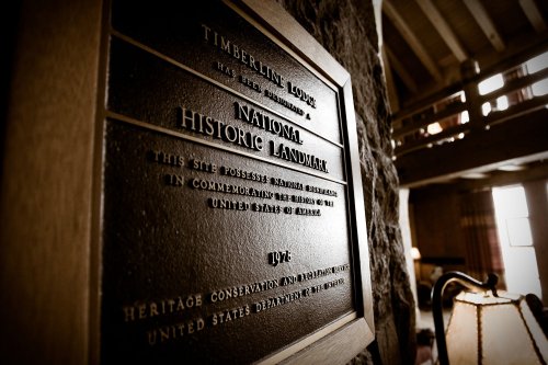 Plaque on a stone wall at Timberline Lodge designating it as a National Historic Landmark, established in 1974.
