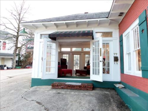 A cozy entrance with open double doors leading into a bright, inviting interior space.