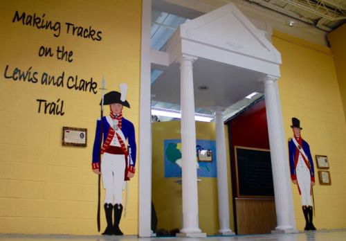 A colorful wall display featuring two soldiers and a columned entrance, promoting the Lewis and Clark Trail.