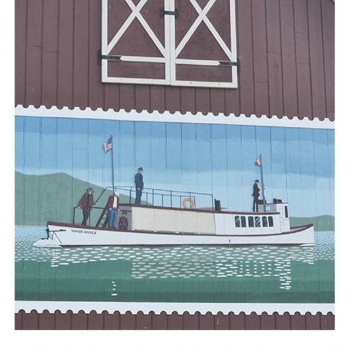 A mural depicting a vintage boat on water, with figures and flags, against a red barn backdrop.