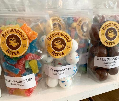 Bags of colorful candies: Sour Patch Kids, Jawbreakers, and Milk Chocolate Malt Balls, labeled with "Brownwood Acres."