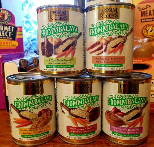 Six cans of Fromm recipes featuring various flavors of Frommbalaya, including lamb, turkey, and beef.