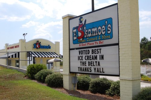 Sign for Ed's Kamoes, promoting "Voted Best Ice Cream in the Delta" with a bright, inviting storefront in the background.