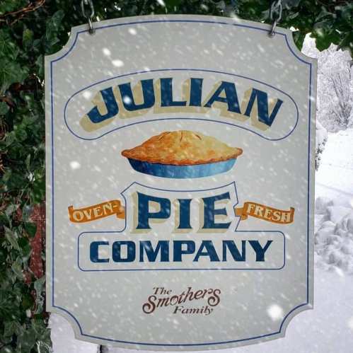 Sign for Julian Pie Company featuring a pie graphic, surrounded by snow, with "Oven Fresh" and "The Smothers Family" below.