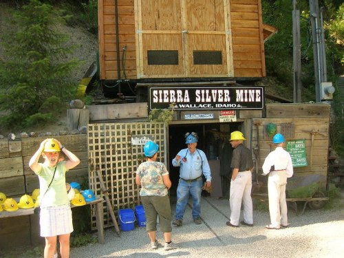 Visitors prepare to enter the Sierra Silver Mine in Wallace, Idaho, wearing hard hats and gathering at the entrance.