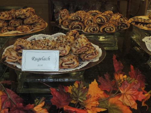 A display of rugelach pastries on a decorative platter, surrounded by autumn leaves.