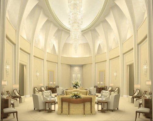 Luxurious interior of a grand room with elegant furniture, chandeliers, and soft lighting.