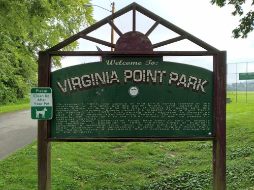 Sign at Virginia Point Park welcoming visitors and providing park information, with a pet cleanup reminder.