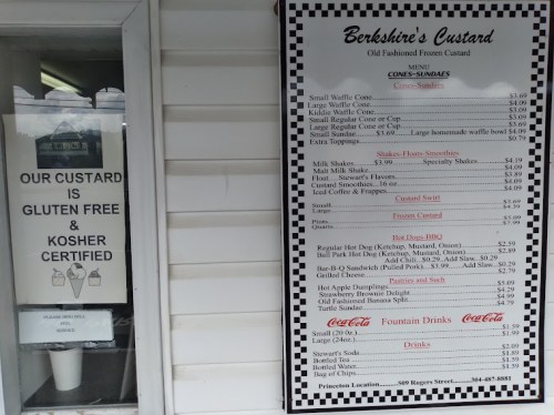 Menu board for Berkshire's Custard featuring frozen treats, shakes, and drinks, alongside a sign about gluten-free options.