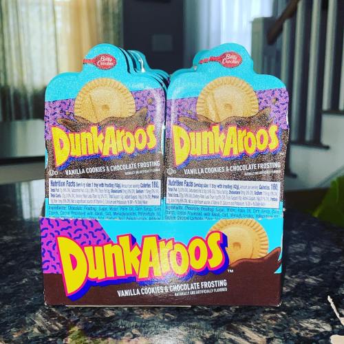 A box of DunkAroos featuring vanilla cookies and chocolate frosting, displayed on a countertop.