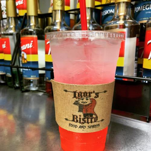 A clear cup filled with a red drink and ice, featuring a straw and a branded sleeve from Igor's Bistro.