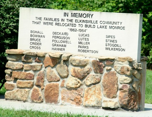Memorial stone listing families relocated for Lake Monroe construction, 1962-1964, with names engraved on a stone base.