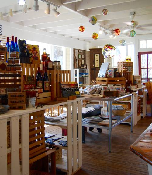 A cozy shop interior filled with wooden displays, colorful decor, and various products for sale.