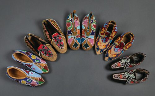 A circular arrangement of colorful, intricately beaded shoes on a gray background.