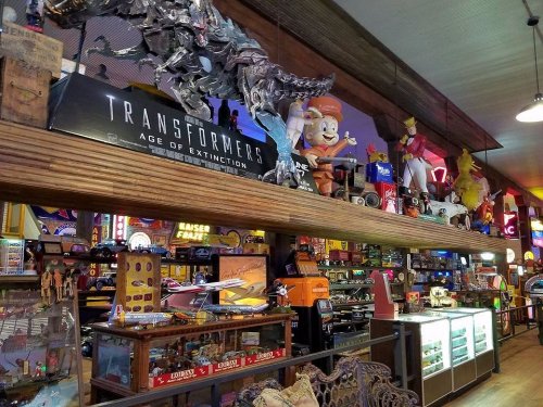 A colorful display of vintage toys and memorabilia, including Transformers and various collectibles on shelves.