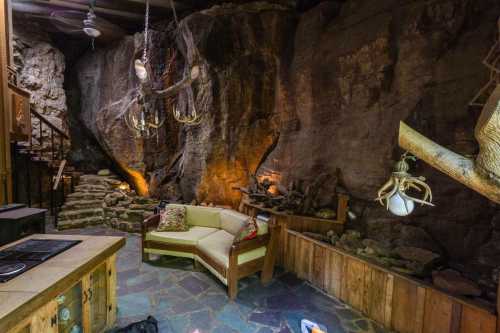 Cozy cave interior with stone walls, wooden furniture, and unique lighting fixtures, creating a rustic atmosphere.