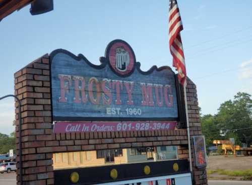 Sign for "Frosty Mug," established in 1960, featuring a beer mug graphic and a phone number for orders.