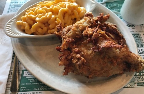 A plate featuring crispy fried chicken and a side of creamy macaroni and cheese.