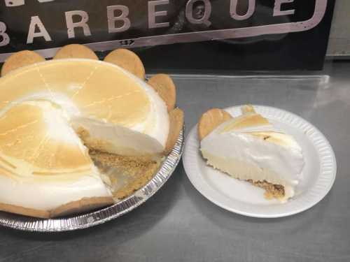 A whole pie with a slice removed, next to a plate with a single slice of creamy dessert.