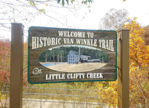 Sign welcoming visitors to the Historic Van Winkle Trail at Little Clifty Creek, featuring a scenic illustration.