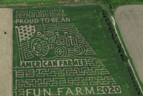 Aerial view of a corn maze featuring a tractor, American flag, and text: "Proud to be an American Farmer Fun Farm 2020."