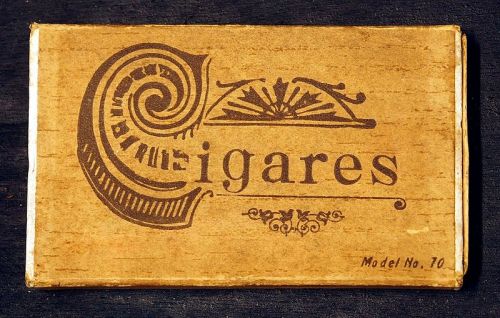 Vintage cigar box with ornate design and the word "Cigares" prominently displayed. Model No. 10 at the bottom.