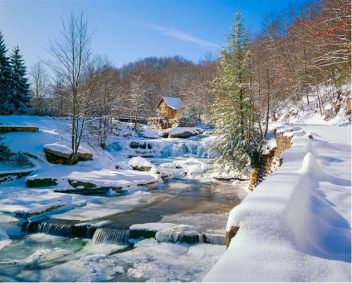 A serene winter landscape featuring a snowy river, frozen waterfalls, and a quaint cabin surrounded by trees.