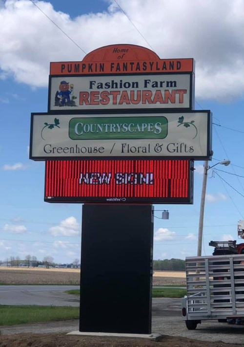 Sign for Fashion Farm Restaurant and Countryside Greenhouse, featuring a digital display for new signs.