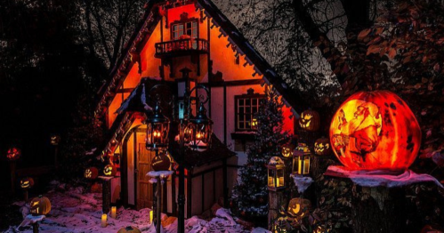 A cozy, illuminated house surrounded by carved pumpkins and lanterns, creating a festive Halloween atmosphere.