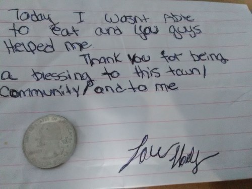 A handwritten note expressing gratitude for help with food, accompanied by a coin.