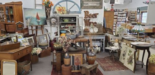 A cozy antique shop filled with vintage furniture, decor, and artwork, creating a charming, nostalgic atmosphere.
