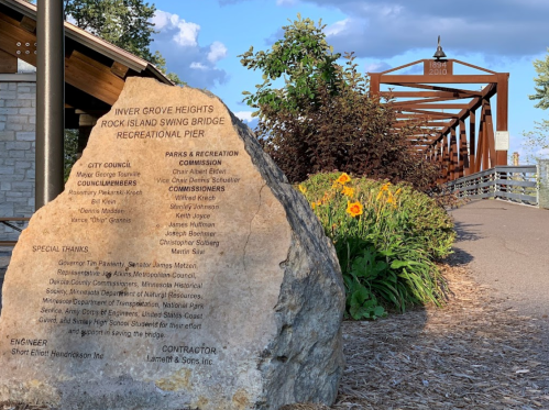 A stone monument lists city officials and thanks for the Rock Island Swing Bridge Recreational Pier in Inner Grove Heights.