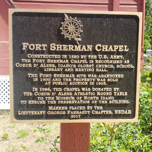 Sign detailing the history of Fort Sherman Chapel, built in 1880, with information about its preservation and donation.