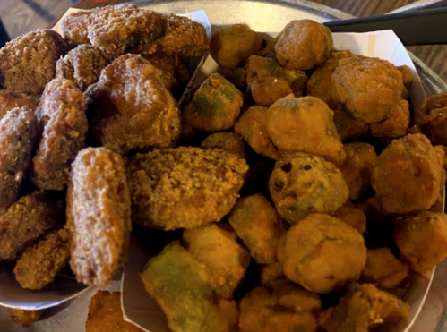 A close-up of two types of fried snacks: one is crispy and golden, the other is slightly green and irregularly shaped.