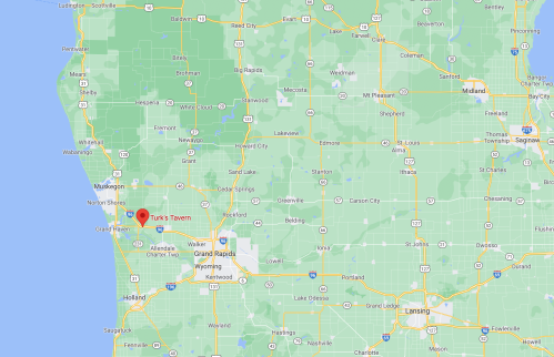 Map showing the location of Turk's Tavern in Michigan, near the coast and surrounded by green areas.