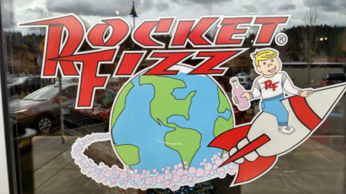 Colorful logo of Rocket Fizz featuring a boy on a rocket with Earth and bubbles in the background.