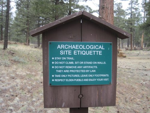 Sign with guidelines for visiting an archaeological site, emphasizing respect for the area and preservation of artifacts.