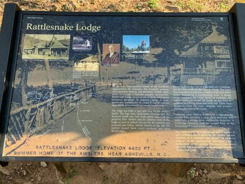 Sign about Rattlesnake Lodge, featuring historical photos and information about its significance near Asheville, NC.