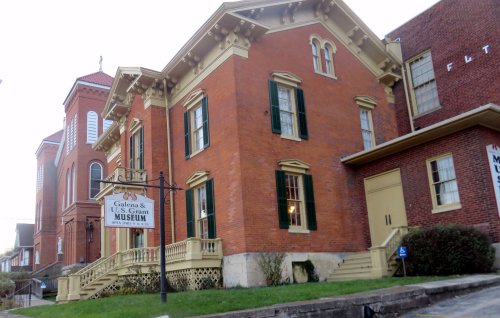 Historic brick building with green shutters, featuring a sign for the Cashtown & U.S. Grant Museum.