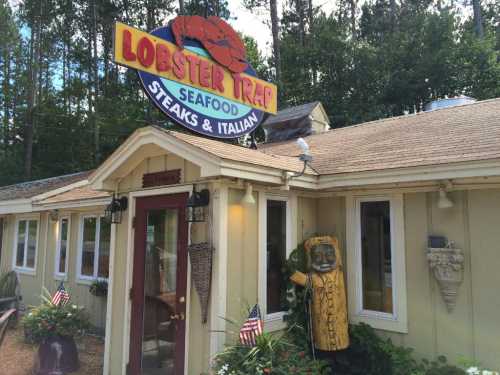 A seafood restaurant called "Lobster Trap" with a sign, surrounded by greenery and decorative flags.