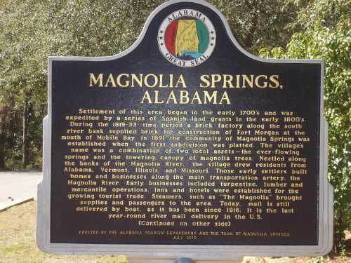 Historical marker about Magnolia Springs, Alabama, detailing its settlement and riverboat history.