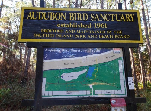 Sign for Audubon Bird Sanctuary, established in 1961, featuring a map of the trails and surrounding areas.