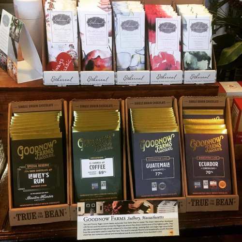 Display of coffee and tea products from Goodnow Farms, featuring various flavors and origins on shelves.