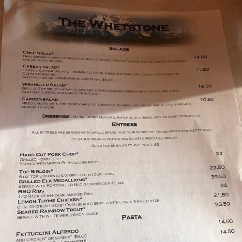 Menu from The Wheystone featuring salads, entrees, and pasta options with prices listed.