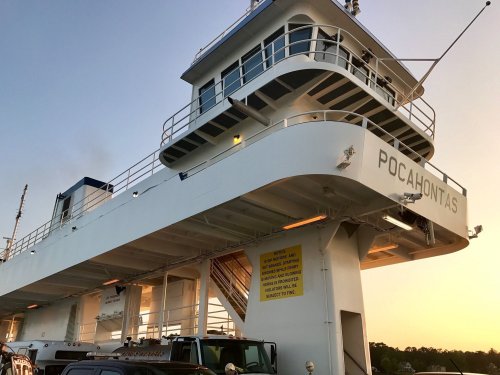 A ferry named "Pocahontas" docked, with a clear sky and sunset in the background.